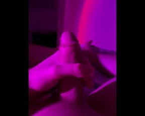 Hot white man masturbating in bed with neon light